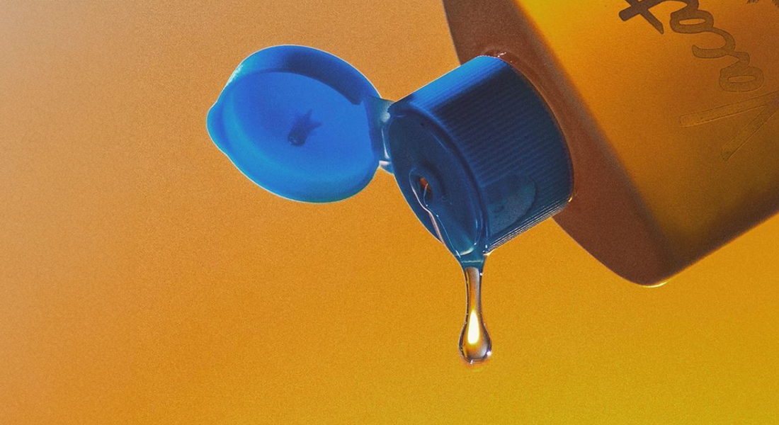 drop falling from oil sunscreen bottle
